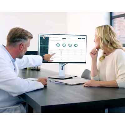 Image of doctor and patient looking at Clinician Portal