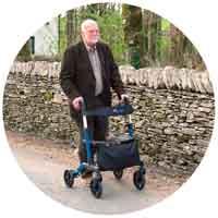 Image of a man walking with a help of rollator